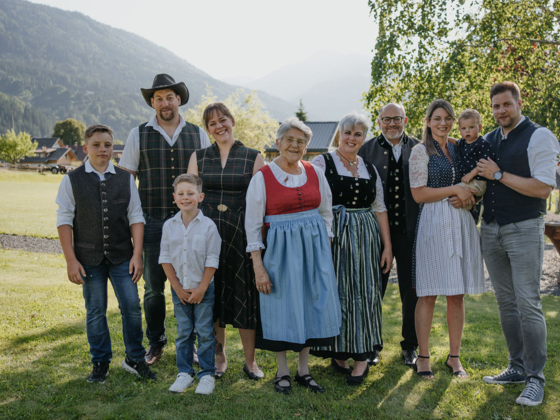 Familie Zerza in Tracht im Garten vorm Haus.